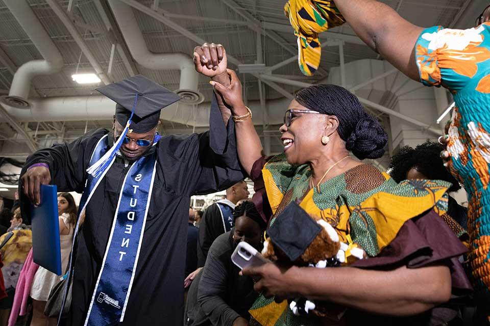 A graduate celebrates with their family