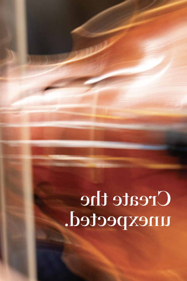 blurred image of a violin with the text Create the Unexpected in white