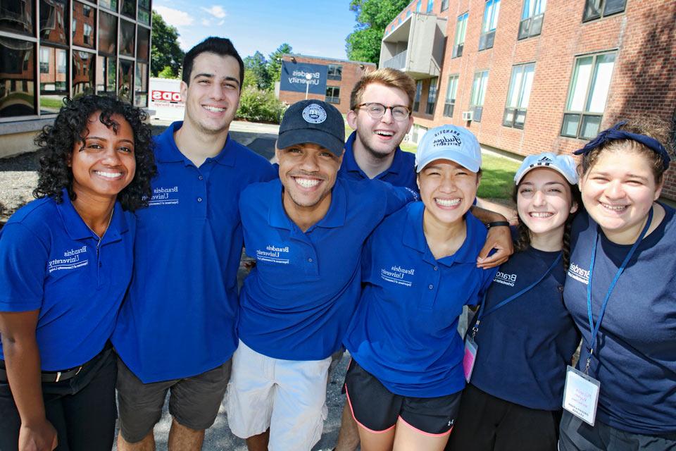 Orientation leaders and Department of Community Living student workers smiling in front of North Quad on move-in day 2018